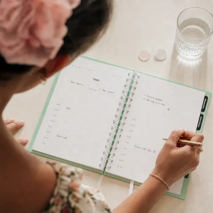 Planning the day in The 1% Planner over coffee
